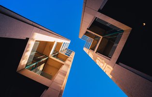 Bx_frog-s-eye-view-architectural-twin-buildings-against-clear-blue-sky.jpg