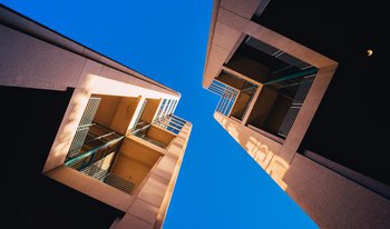 Bx_frog-s-eye-view-architectural-twin-buildings-against-clear-blue-sky.jpg
